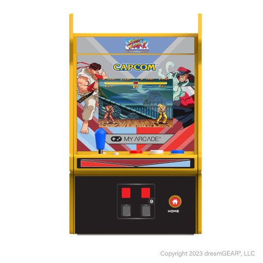 Miniature arcade machine with Super Street Fighter II Turbo game on a white background
