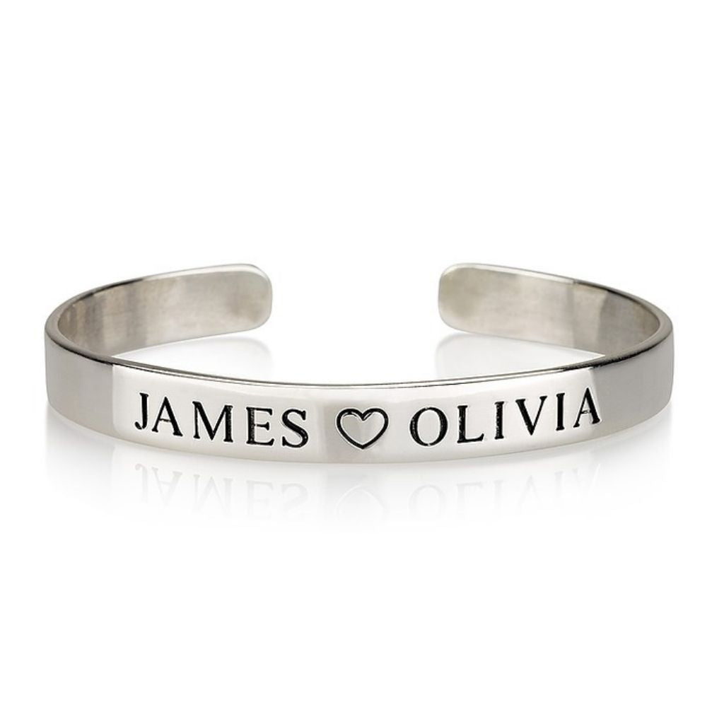 Silver bracelet with 'JAMES ❤️ OLIVIA' engraved on a white background