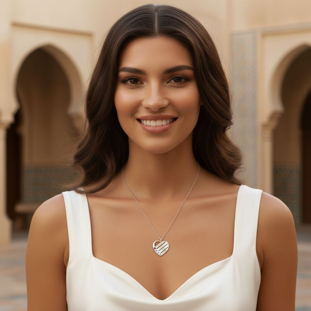 Woman wearing a heart-shaped necklace in an outdoor setting with arches.
