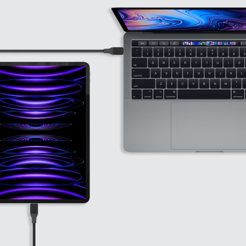 Laptop connected to a external display on a white surface