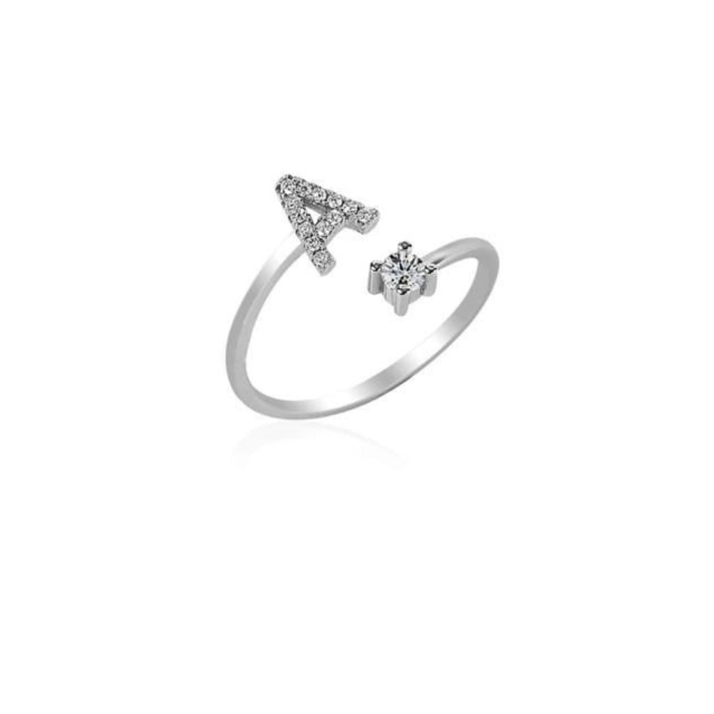 Silver ring with letter 'A' and gemstone on a white background