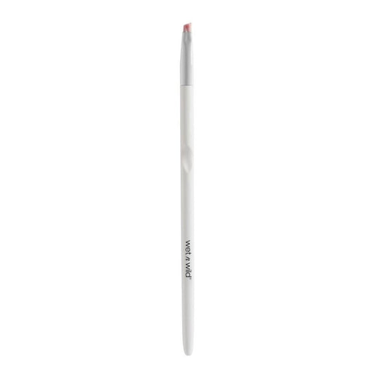 White makeup brush with red bristle tip on a white background