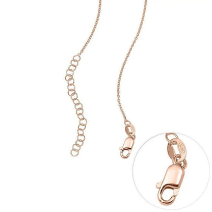 Rose gold chain necklace with a clasp on a white background