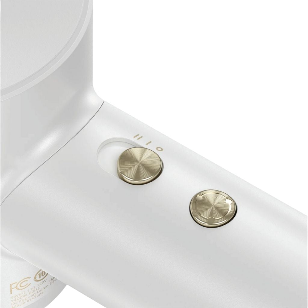 Close-up of a white hair dryer with gold buttons on a white background