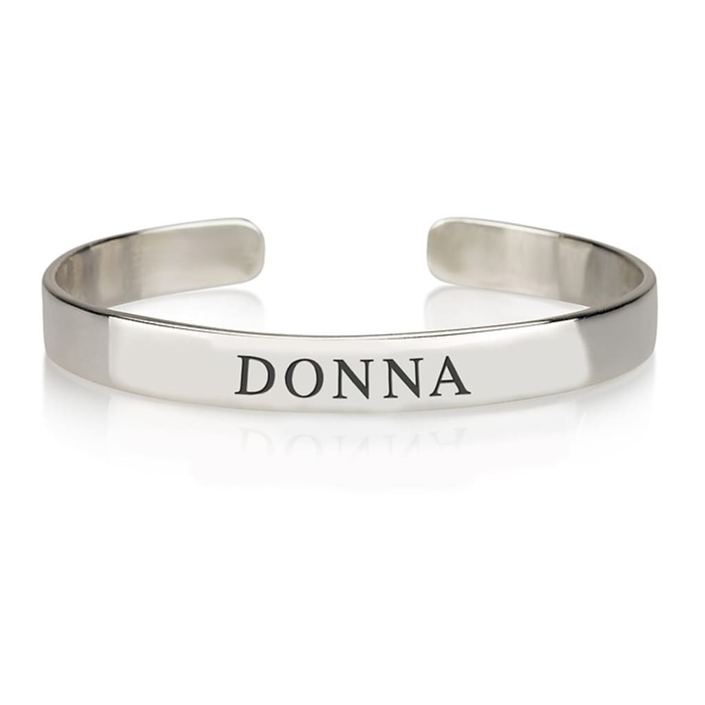Silver bracelet with 'DONNA' engraved on a white background