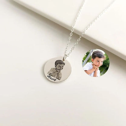 Necklace with a round pendant featuring an engraved image of a young boy and the name 'Henry'.
