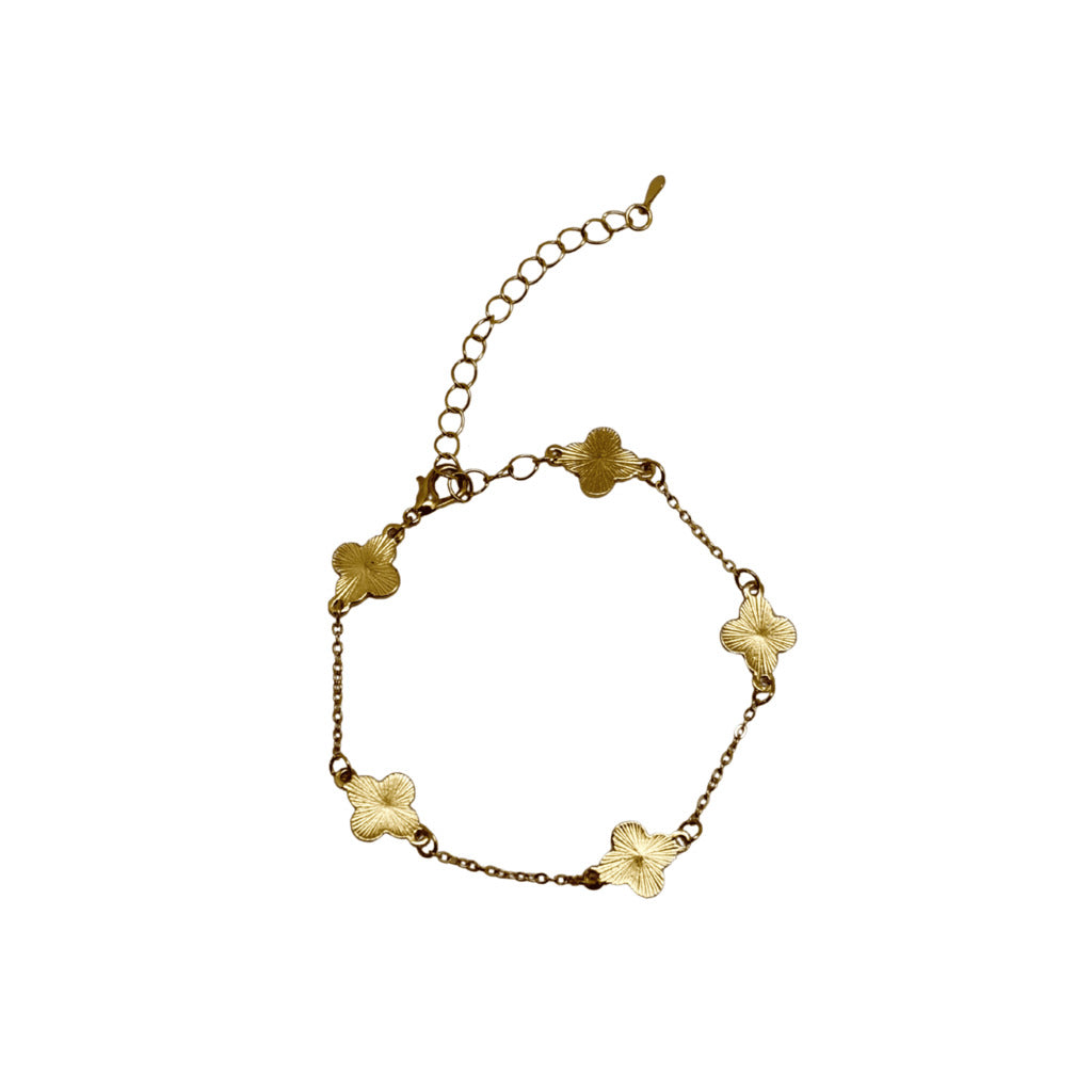 Gold bracelet with floral designs on a white background