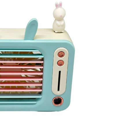 Toy television set with rabbit ears and a small rabbit figure on a white background