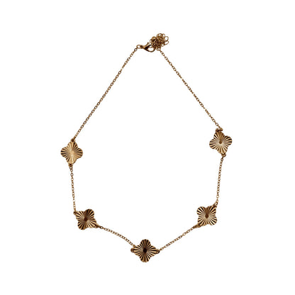 Gold necklace with floral links on a white background