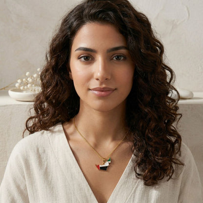 Woman wearing a necklace with a flag pendant against a neutral background