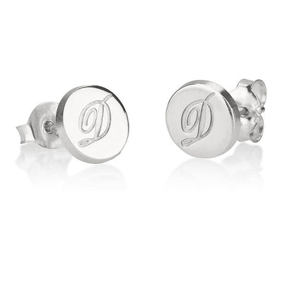 Silver earrings with an engraved letter 'D' on a white background
