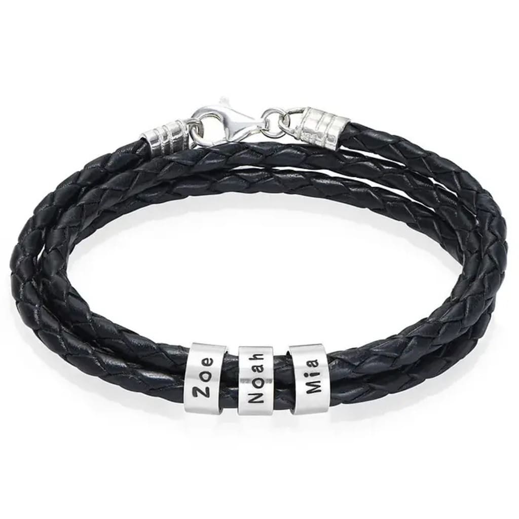 Black braided leather bracelet with silver name beads on a white background