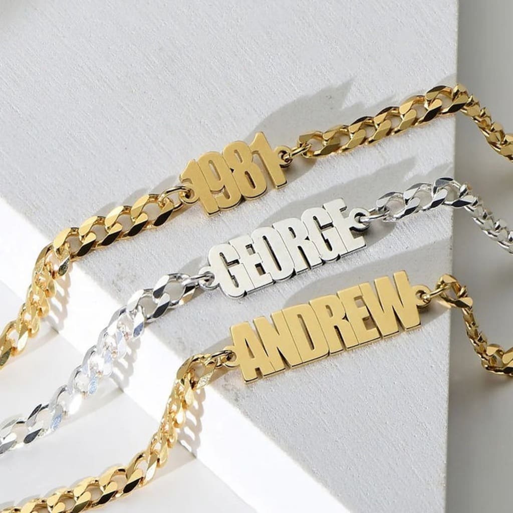 Three name bracelets in gold, silver, and gold on a white background
