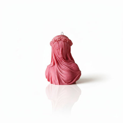 Pink bust sculpture with draped fabric on a white background