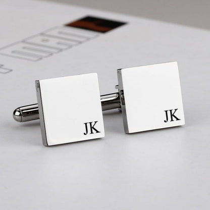 Silver cufflinks with 'JK' initials on a light background