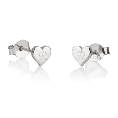 Heart-shaped silver earrings with engraved initials on a white background