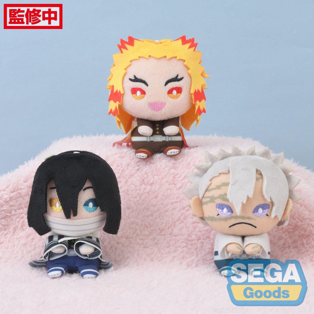 Three anime-style figurines on a pink cushion with 'SEGA Goods' branding.