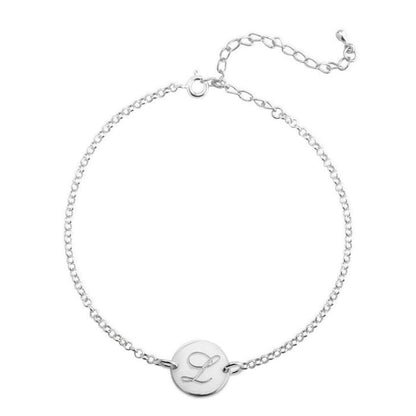 Silver bracelet with a round charm featuring the letter 'L' on a white background