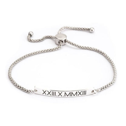 Silver bracelet with Roman numeral engraving on a white background