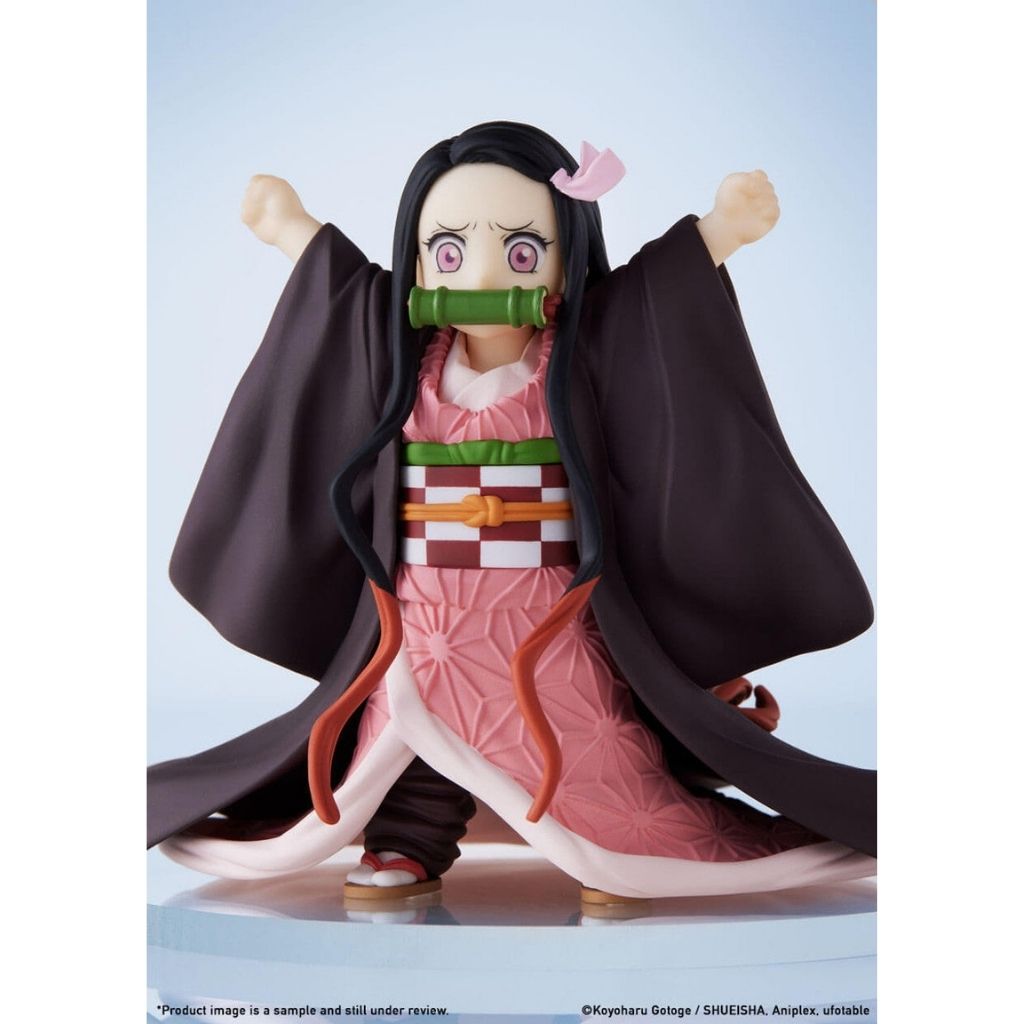 Anime character figurine with long black hair and pink outfit on a light blue background