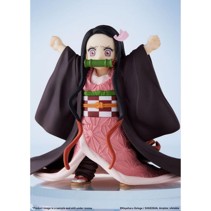 Anime character figurine with long black hair and pink outfit on a light blue background