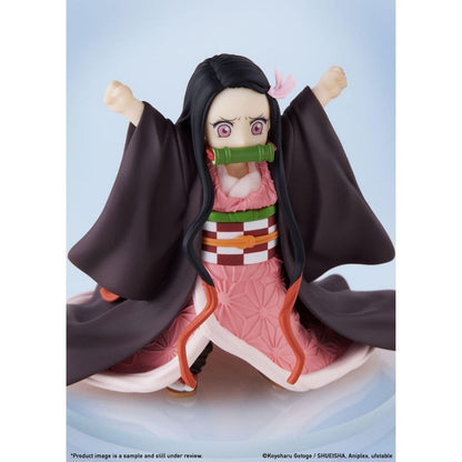 Anime character figurine with black hair and pink outfit on a light blue background