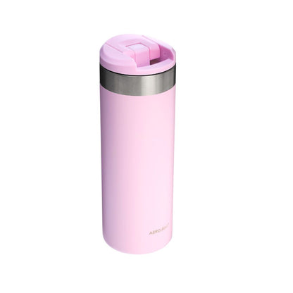 Pink insulated travel mug with a silver lid on a white background