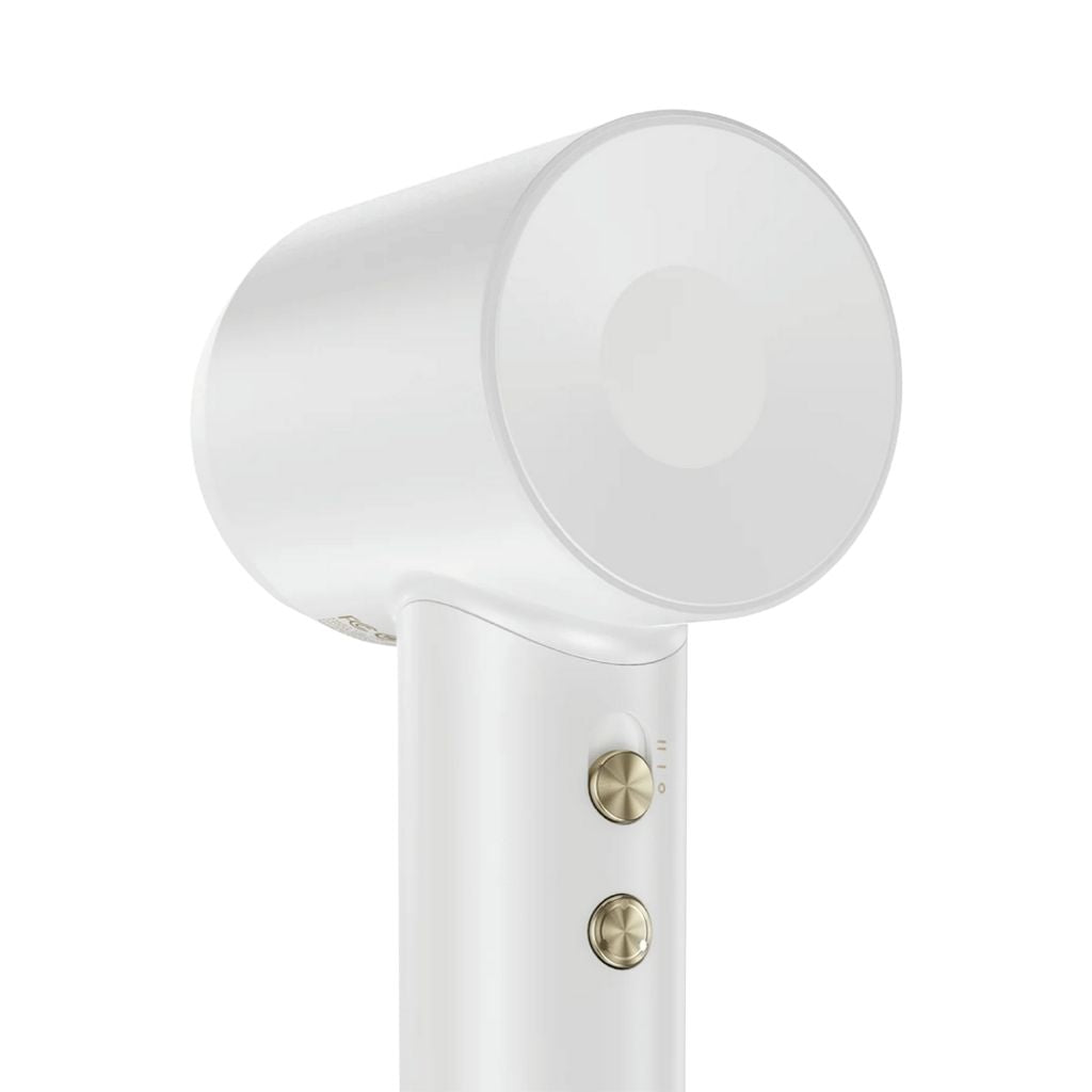 White hair dryer with gold accents on a white background