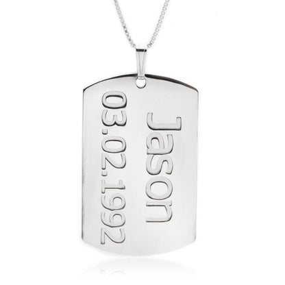 Silver dog tag pendant with engraved name and date on a white background