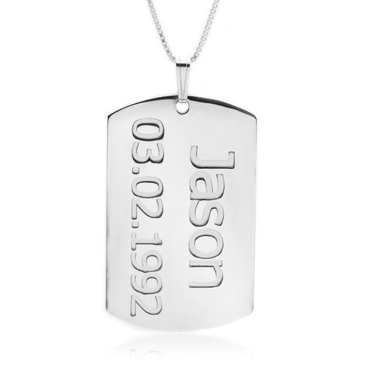 Silver dog tag pendant with engraved name and date on a white background