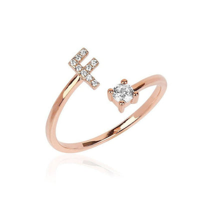 Rose gold ring with diamond accents on a white background