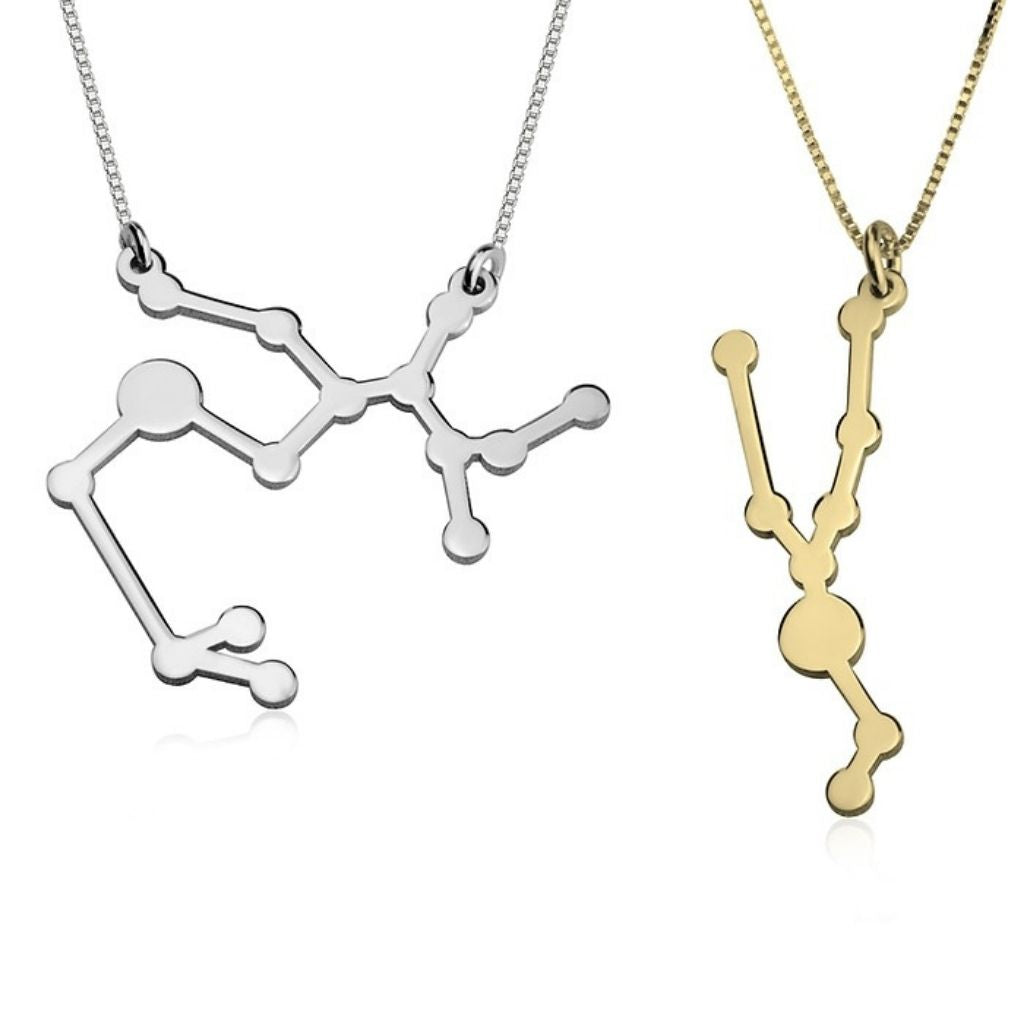 Two molecular structure necklaces, one silver and one gold, on a white background.