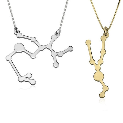 Two molecular structure necklaces, one silver and one gold, on a white background.