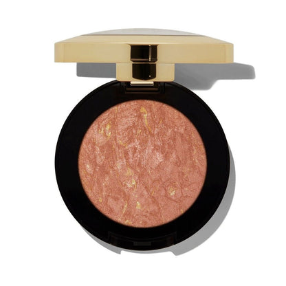 Compact blush with gold lid on a white background