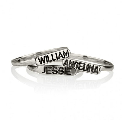 Three silver name rings with 'William', 'Angelina', and 'Jessie' on a white background