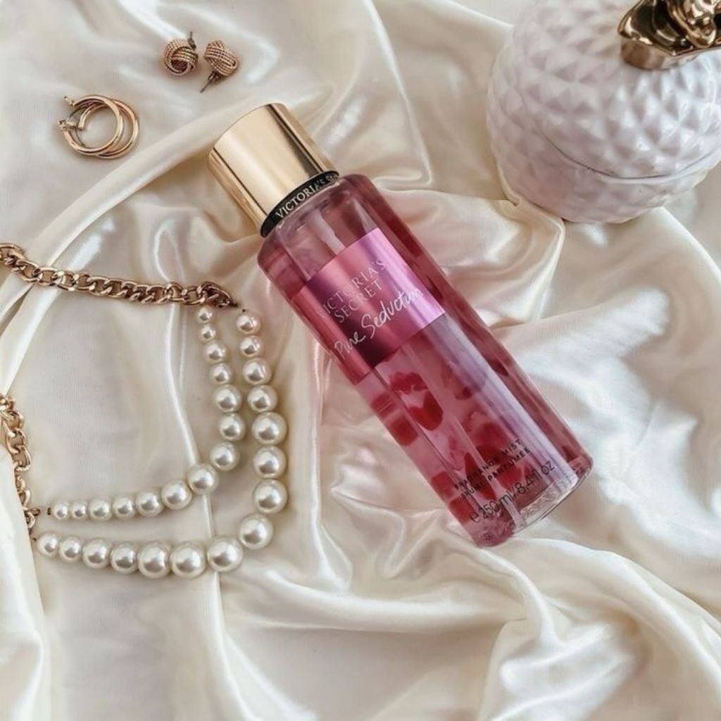 Perfume bottle with jewelry on a soft fabric background