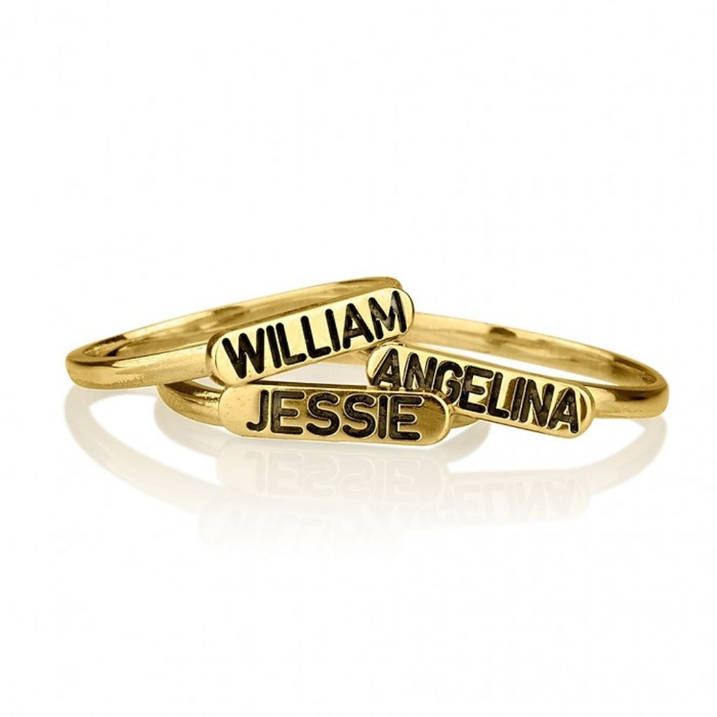 Gold name rings with 'William', 'Angelina', and 'Jessie' on a white background