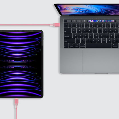 Laptop and tablet connected by a cable on a white background
