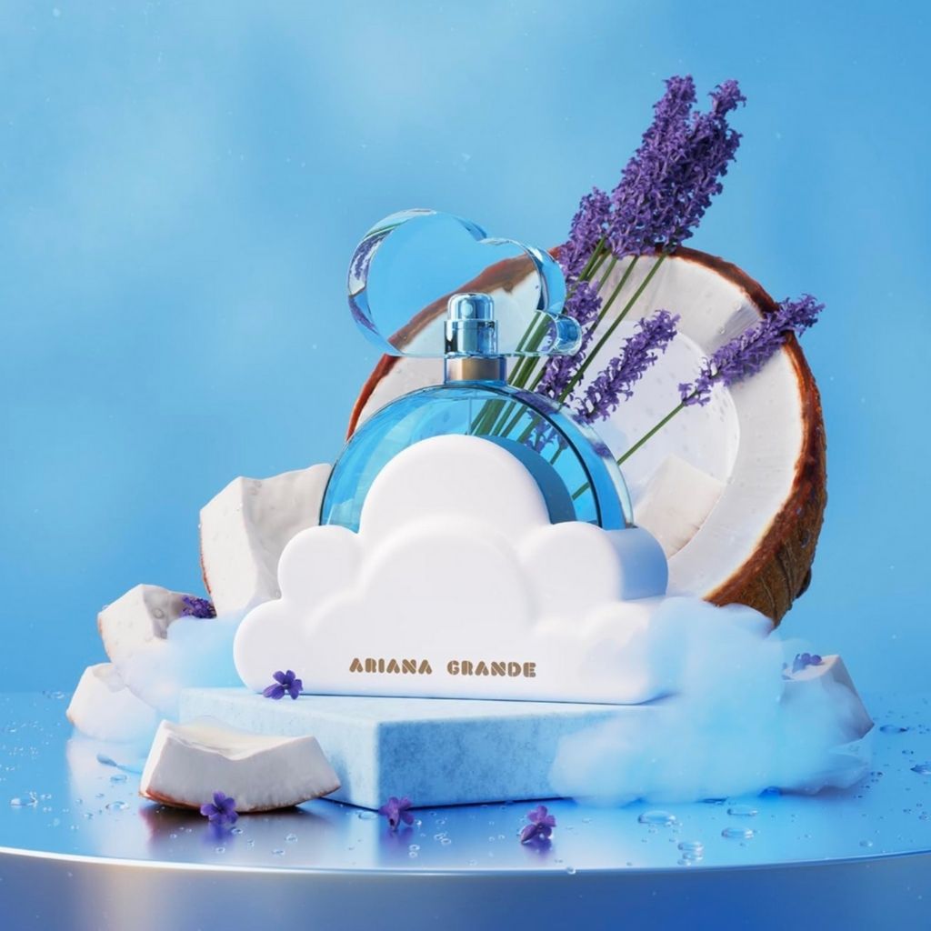 Perfume bottle with cloud design and 'Ariana Grande' branding on a blue background with coconut and lavender.