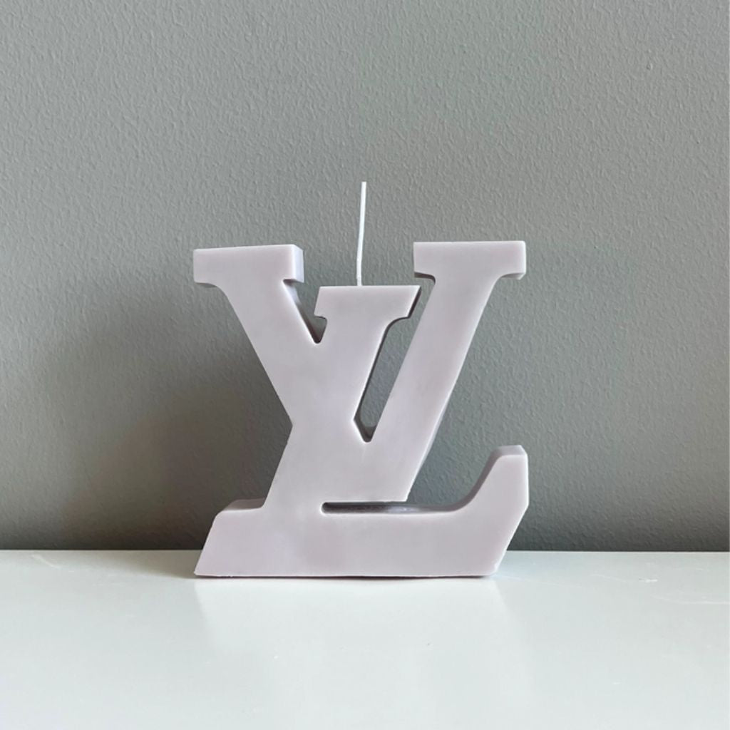 White candle shaped like a logo on a gray background
