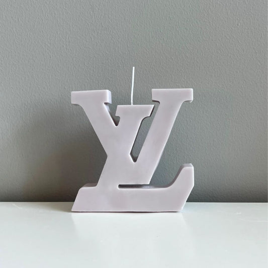 White candle shaped like a logo on a gray background