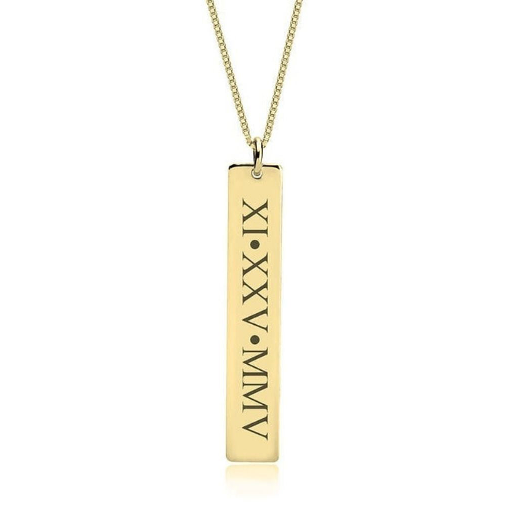 Gold necklace with a vertical bar pendant featuring Roman numerals on a white background