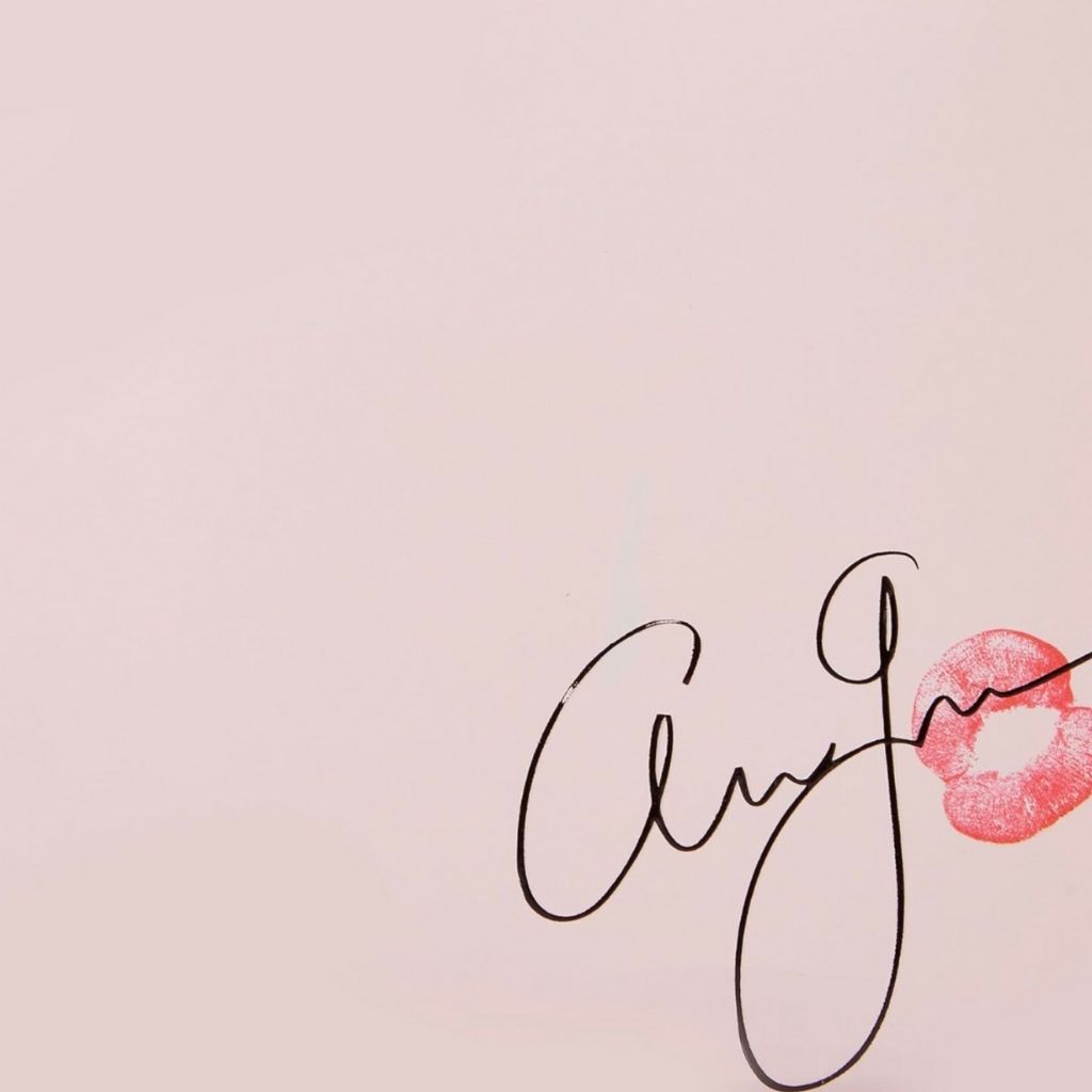 Handwritten name 'Ally' with a pink lipstick mark on a light pink background