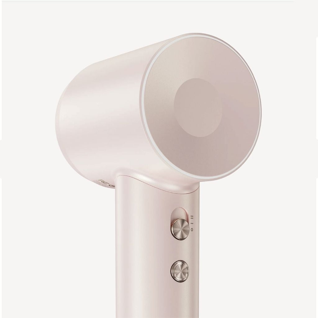 Close-up of a pink hair dryer on a white background