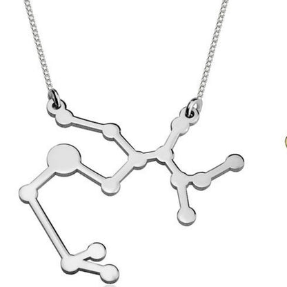 Silver molecular structure pendant on a chain against a white background