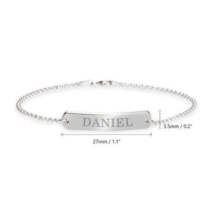 Silver bracelet with engraved name 'DANIEL' on a white background