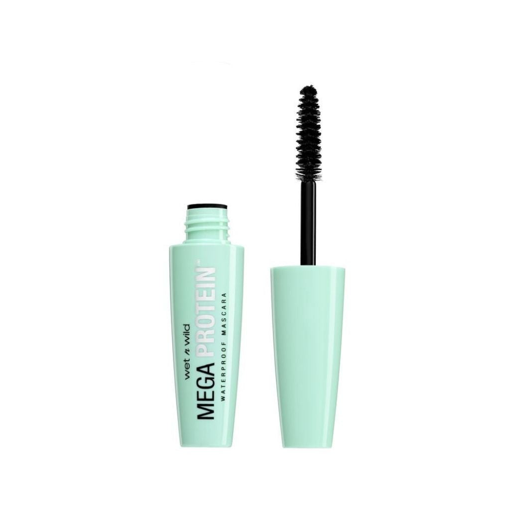 Mascara with green casing and black wand on a white background