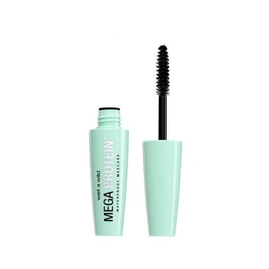 Mascara with green casing and black wand on a white background