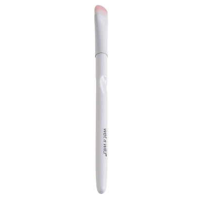 White makeup brush with pink bristle tip on a white background