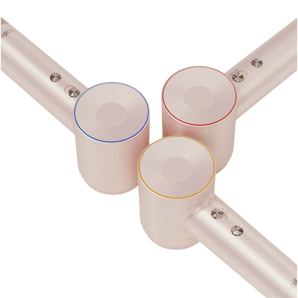 Close-up of a hair dryer with color-coded nozzles on a white background